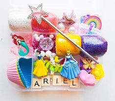 a plastic container filled with princess figurines and other items on top of it