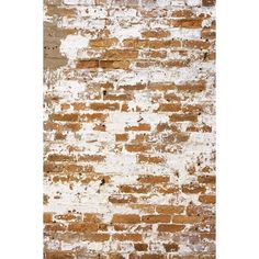 an old brick wall with white paint on it