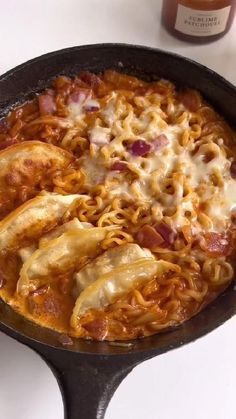 an iron skillet filled with pasta and sauce