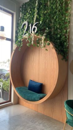 a green plant is growing on the side of a wooden wall with a circular seat