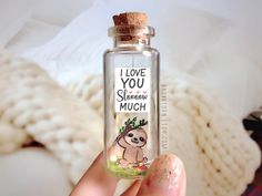 a person holding up a bottle with a slotter on it that says i love you, sleep much