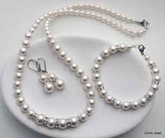 "This vintage inspired set comes with necklace, bracelet and earrings.  Swarovski pearls in your color of preference.  Makes a perfect gift for bridesmaids, maid of honor, mother of the bride or just for someone special! If you need a different color pearl contact me to check availability.  Perfect for any classy bride! Necklace, This classic and elegant necklace has graduated Swarovski pearls in ivory. Pearls in the front of the necklace measure 10 mm and are separated with rhinestone roundelle Handmade Pearl Jewelry Sets For Wedding, Pearl Jewelry Set With Pearl Charm For Wedding, Handmade Elegant Wedding Jewelry Sets, Pearl Drop Round Beads Jewelry Set For Wedding, Pearl Drop Wedding Jewelry Sets With Round Beads, Classy Bride, Bridal Jewelry Pearl Sets, Bridesmaid Jewelry Set, Pearl Bridesmaid Jewelry