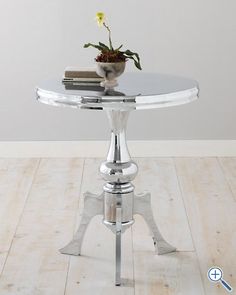 a glass table with a flower on top