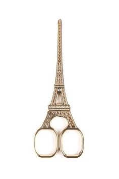 a pair of scissors with the eiffel tower in the background on a white background