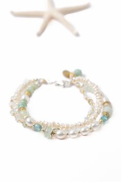 The Serenity Collection is beloved classic line from Anne Vaughan Designs. Featuring a soft colorway, this bracelet is ideal for pairing with other items from the collection. Sterling Silver (lead and nickel free) Freshwater Pearl, Amazonite, Aquamarine 7.5-8.5", adjustable with sterling silver lobster claw clasp We hand select our natural materials, thus there may be slight variations in color and/or size that will not detract from the overall aesthetic Our unique handcrafted designer jewelry f Elegant Double Strand Gemstone Beads Bracelets, Elegant Double Strand Bracelets With Gemstone Beads, Elegant Double Strand Natural Stones Bracelets, Floyd Va, Multistrand Bracelet, Silver Gold Earrings, Silver Gold Necklace, Aquamarine Bracelet, Multi Strand Bracelet