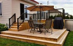 a deck with chairs and an umbrella on it