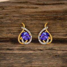 * Metal Material - 18kt Yellow Gold * Gold Weight - 3.640 gram * Gemstone - Natural Tanzanite * Tanzanite Size - 6x8 Oval * Tanzanite Weight - 2.40 carat * Diamond - Natural Diamond * Diamond Size - 1.2 mm Round * Diamond Weight - 0.36 carat * 18kt Hallmarked * Free Shipping * High-Quality Manufacturing * Made in INDIA With Love We Assure Your Satisfaction With Our High-Quality Jewelry ※ Please let us know if you have any questions or requests. THANK YOU FOR VISITING OUR SHOP:) HAVE A NICE DAY:) Formal Tanzanite Earrings In Fine Jewelry Style, Tanzanite Gemstone Earrings For Formal Occasions, Hallmarked Pear-shaped Diamond Earrings For Anniversary, Formal Tanzanite Gemstone Earrings, Pear-shaped Hallmarked Diamond Earrings For Anniversary, Gold-plated Yellow Gold Bridal Earrings For Formal Occasions, Formal Gold-plated Yellow Gold Bridal Earrings, Formal Yellow Gold-plated Bridal Earrings, Formal Yellow Gold Plated Bridal Earrings