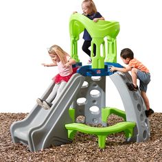 three children playing on a green and gray play set