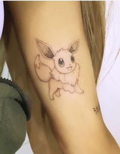 a woman's arm with a small tattoo of a pikachu on it