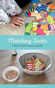 a child playing with matching socks on the floor next to a bowl of crackers