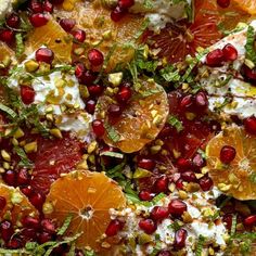 an orange and pomegranate salad with yogurt, nuts, and herbs