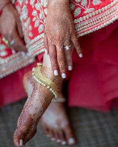 a woman's hands with henna and bracelets