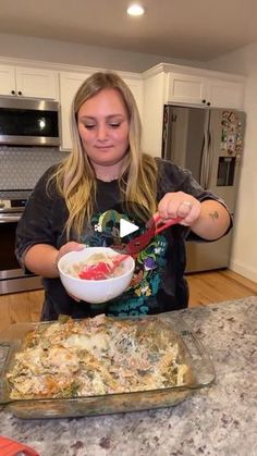 a woman is preparing food in the kitchen with her knife and bowl on the counter