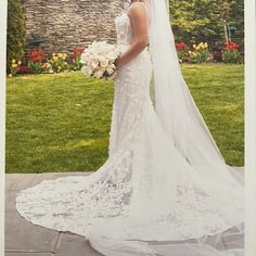 a woman in a wedding dress is posing for a photo with her veil over her head