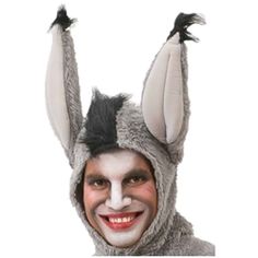 a man wearing a bunny costume with his hands in the air while smiling at the camera