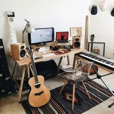 a room with a keyboard, guitar and other musical instruments