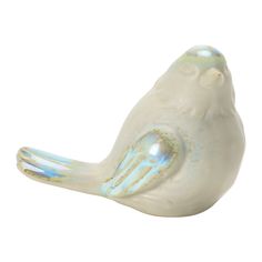 a glass bird figurine sitting on top of a table