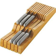 a set of knives sitting on top of a wooden holder with four knives in it