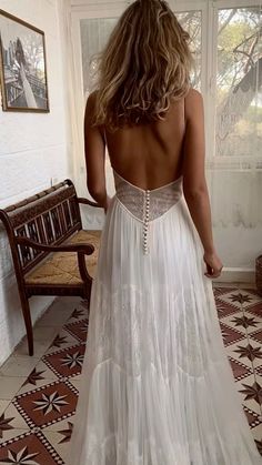 the back of a woman's white wedding dress