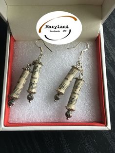 two wine cork earrings in a red box