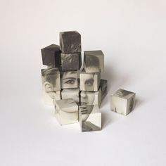 a group of cubes sitting next to each other on top of a white surface