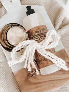 a bottle of lotion sitting on top of a white towel