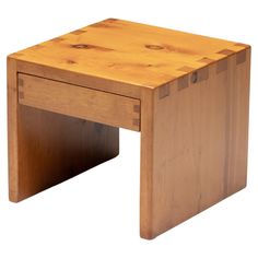 a small wooden table sitting on top of a white floor