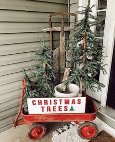 a red wagon with christmas trees in it