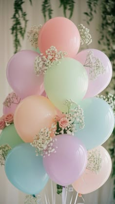 a bunch of balloons with baby's breath on them