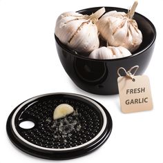 garlic in a black bowl next to a fresh garlic tag