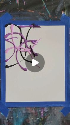 an abstract painting with blue frame and white paper in the middle that has pink, black and purple swirls on it