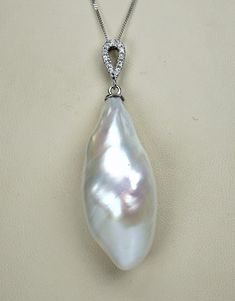 Gorgeous vintage solid 18 carat white gold and huge Baroque pearl diamond pendant ! Absolutely spectacular piece!  Measurements: pearl length 3,3cm (1,29") by width at widest part 1,4cm (0,55")  12 diamonds 1,5mm (0,06")  chain length 45cm (17,71")  total weight 8,2 grams Pendant is marked with mark 750 for 18 carat gold. Chain is marked also for 18ct gold.  Condition of the pendant is very good. No damage and scratches on the pearl, some natural imperfections. Diamond colorless with VS1 clarity Formal Pear-shaped Pearl Necklace, Luxury Silver Teardrop Pearl Necklace, Formal Pear-shaped Diamond Pearl Necklace, Formal Pear-shaped Pearl Pendant Necklace, Formal Drop-shaped White Gold Pearl Necklace, Formal Drop White Gold Pearl Necklace, Formal Drop Pearl Necklace In White Gold, Elegant Pearl Necklace With Large Pendant, Formal Silver Pear-shaped Pearl Necklace