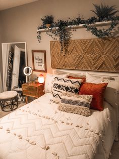 a bed sitting in a bedroom next to a dresser and window with plants on it