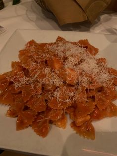 a white plate topped with pasta and sauce