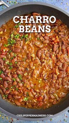 a skillet filled with beans and garnished with parsley on the side