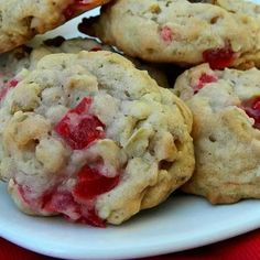 a white plate topped with cookies covered in strawberry pie fillings on top of a red table cloth