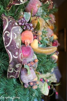 a close up of a christmas tree with fruit on it