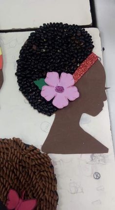 the cake is decorated with black women's hair and flowers