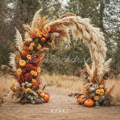 an outdoor wedding arch decorated with flowers and pumpkins