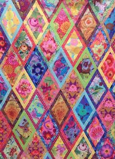 a colorful quilt is hanging on the wall