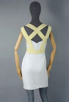 Features - 100% Authentic THIERRY MUGLER. - Short white dress with yellow stripe crisscross panel at the back. - Bow/ ribbon accent at the centre front. - Snap buttons and zipper closure at the back. - Label reads: THIERRY MUGLER PARIS, Made in France. - Size 42. - Fabric content: 100% Silk, 100% Cotton. - Fully lined. - Very good vintage condition. Measurements taken laid flat, please double bust, waist and hips: Shoulder: 15.74 inches (40 cm) Bust: 16.92 inches (43 cm) Waist: 14.56 inches (37 White Dresses With Crisscross Straps And Cross Back, White Cross Back Dresses With Crisscross Straps, White Cross Back Dress With Tie Detail, White Dresses With Crisscross Straps For Spring, White Fitted Dress With Crisscross Straps, Vintage Thierry Mugler, Short White Dress, Layered Choker Necklace, Ribbon Dress