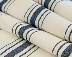 several blue and white striped fabric are stacked on top of each other in this close up photo