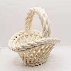 a white basket sitting on top of a table