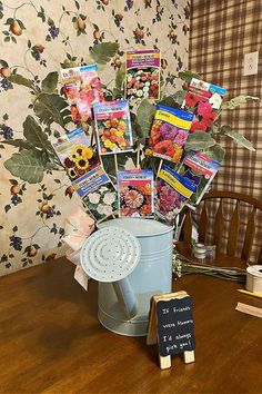 a bucket filled with seed packets sitting on top of a table next to a chalkboard