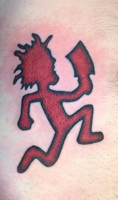 a man's arm with a tattoo on it that has a red and black design