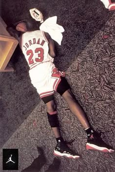 a basketball player laying on the floor with his head down and wearing a jersey that says jordan 23