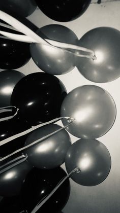 black and white photograph of balloons hanging from the ceiling