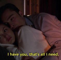 a man and woman laying in bed with the caption i have you, that's all i need