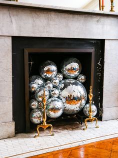 a fire place filled with lots of shiny silver balls