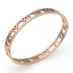 Hinged clasp bracelet with laser-cut Roman numeral design 14K gold-plated, 14K rose gold-plated, rhodium-plated (silver tone) 58mm diameter equals approximately 7 inches circumference Stainless steel Tarnish-free ℹ be sure to measure your wrist before purchasing; contact us with any sizing questions at support@thejewelparlor.com Roman Numeral Design, Roman Numeral Bracelet, Clasp Bracelet, Roman Numeral, Bracelet Clasps, Roman Numerals, 18k Rose Gold, Rose Gold Plates, Rhodium Plated